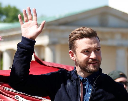Actor and singer Justin Timberlake waves during a photocall to promote the movie 