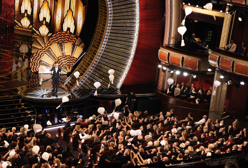 Host Jimmy Kimmel speaks as donuts fall onto the audience at the Oscars on Sunday, Feb. 26, 2017, at the Dolby Theatre in Los Angeles. (Photo by Chris Pizzello/Invision/AP)