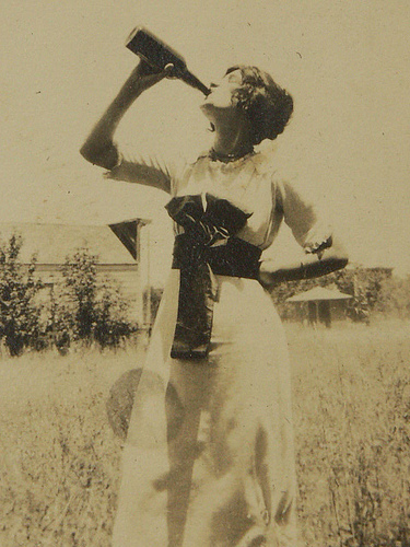 Woman_drinking_from_whiskey_bottle_